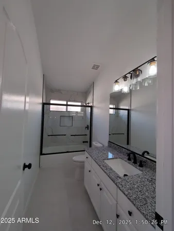 a bathroom with a double vanity sink and mirror