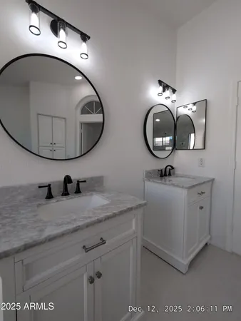 a bathroom with a double vanity sink and a mirror