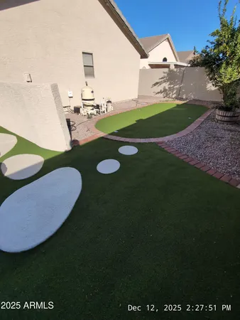 a view of a backyard with table and chairs