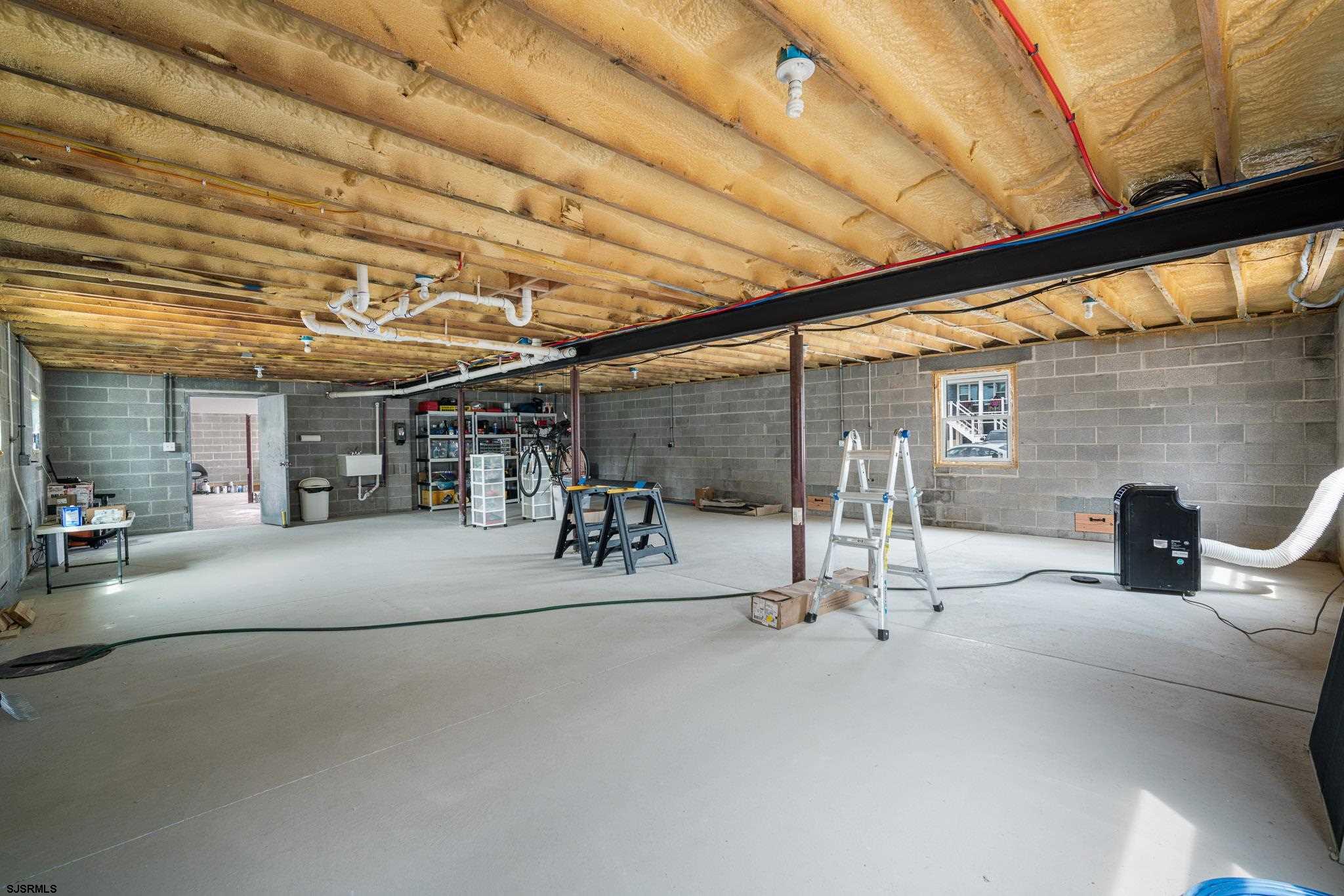 440 Hackney Place Brigantine, NJ 08203 - Photo 15 of 45 a view of a patio with table and chairs under an umbrella