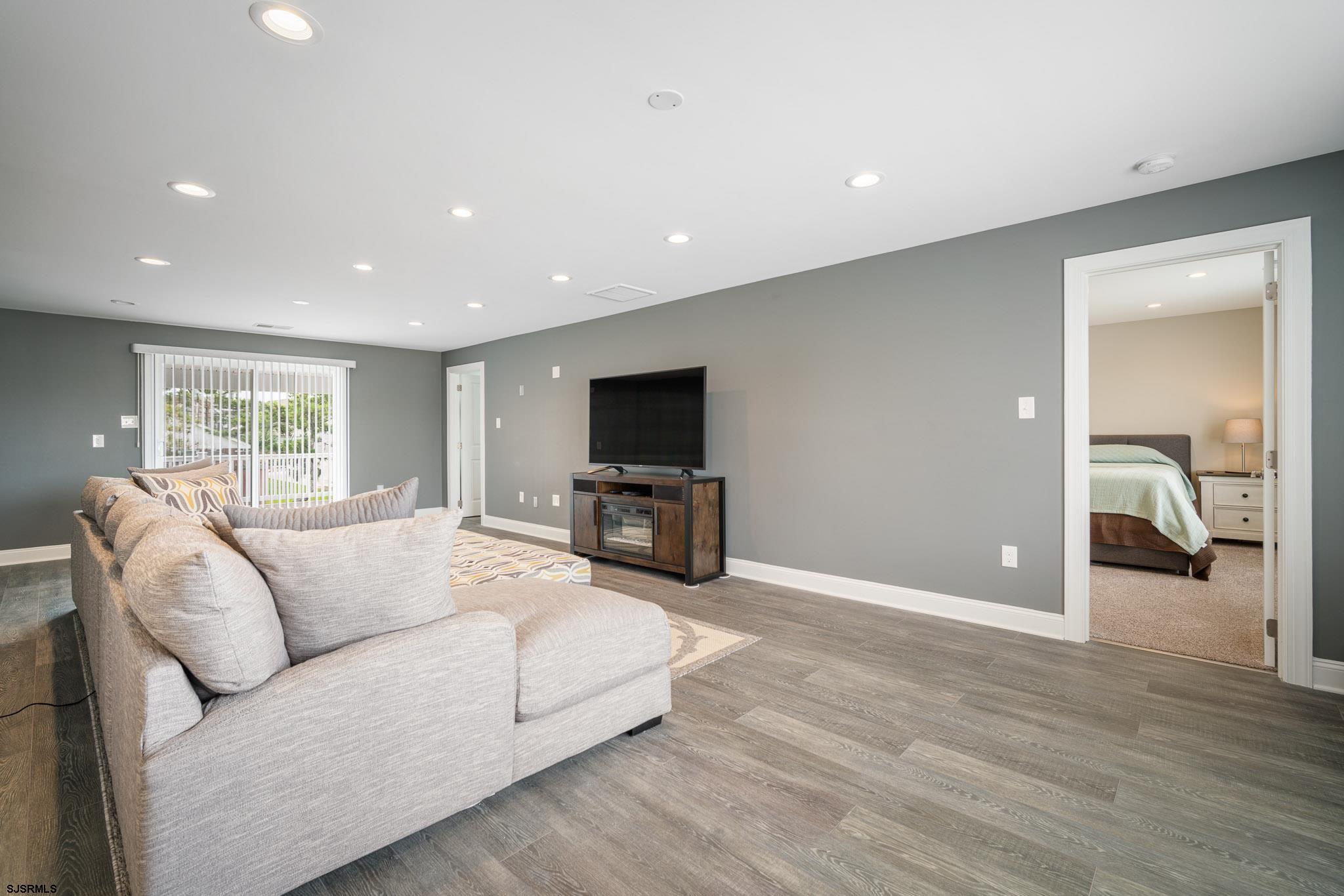 440 Hackney Place Brigantine, NJ 08203 - Photo 19 of 45 a living room with furniture and a flat screen tv