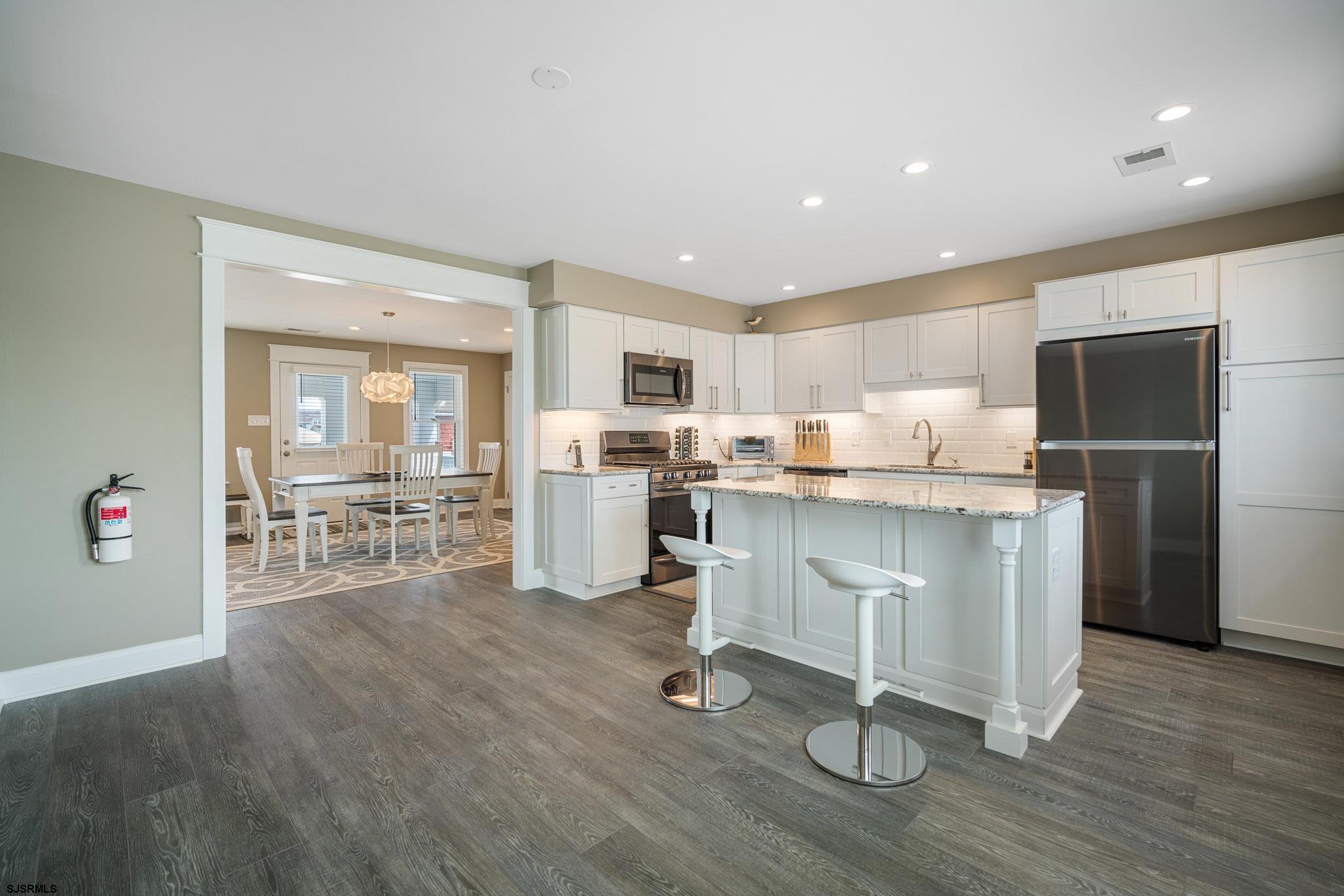 440 Hackney Place Brigantine, NJ 08203 - Photo 20 of 45 a kitchen with white cabinets and stainless steel appliances