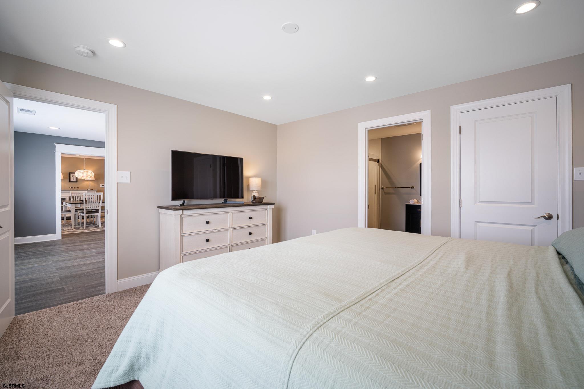 440 Hackney Place Brigantine, NJ 08203 - Photo 28 of 45 a bedroom with a bed and a flat screen tv in it