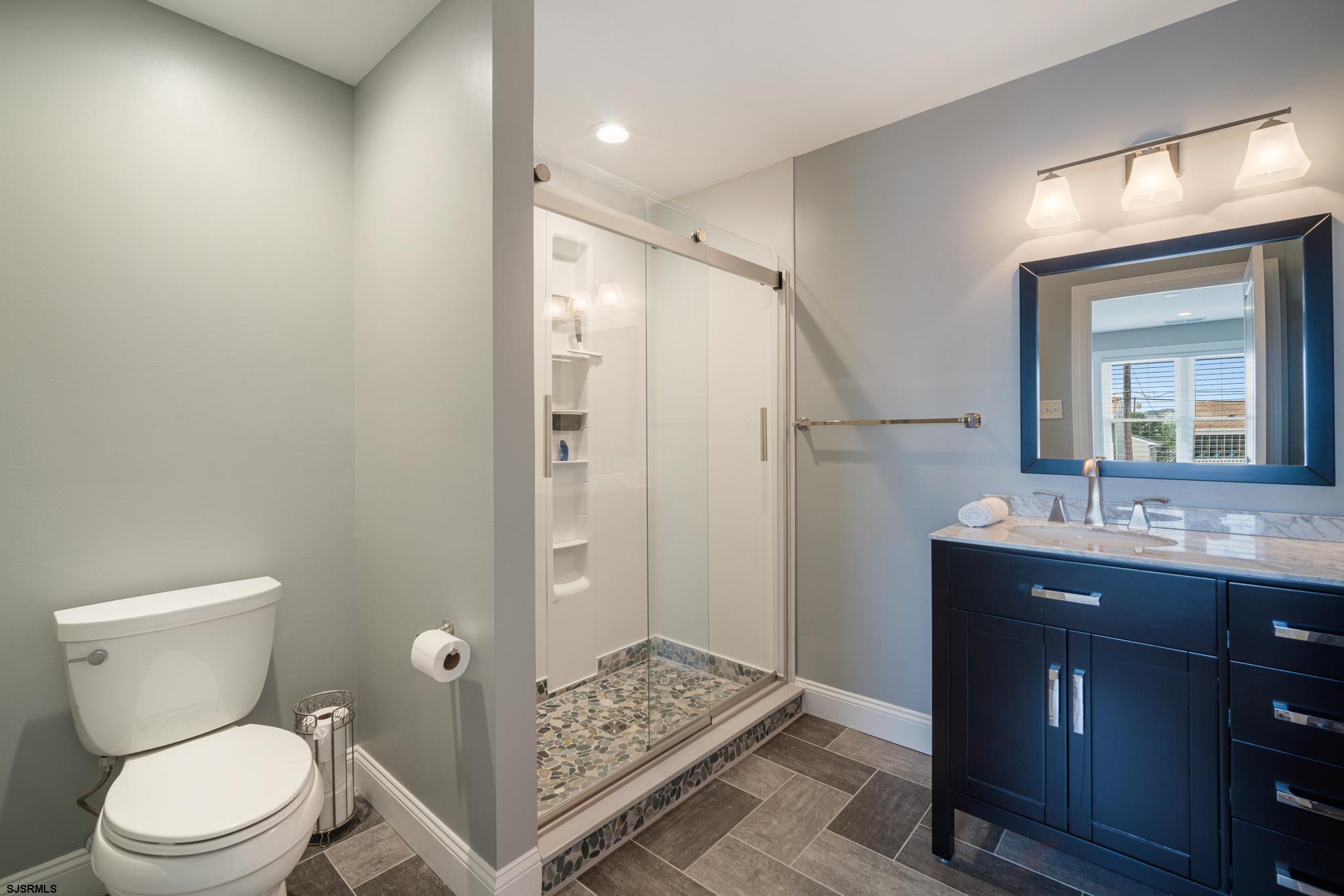 440 Hackney Place Brigantine, NJ 08203 - Photo 30 of 45 a bathroom with a granite countertop sink toilet and shower