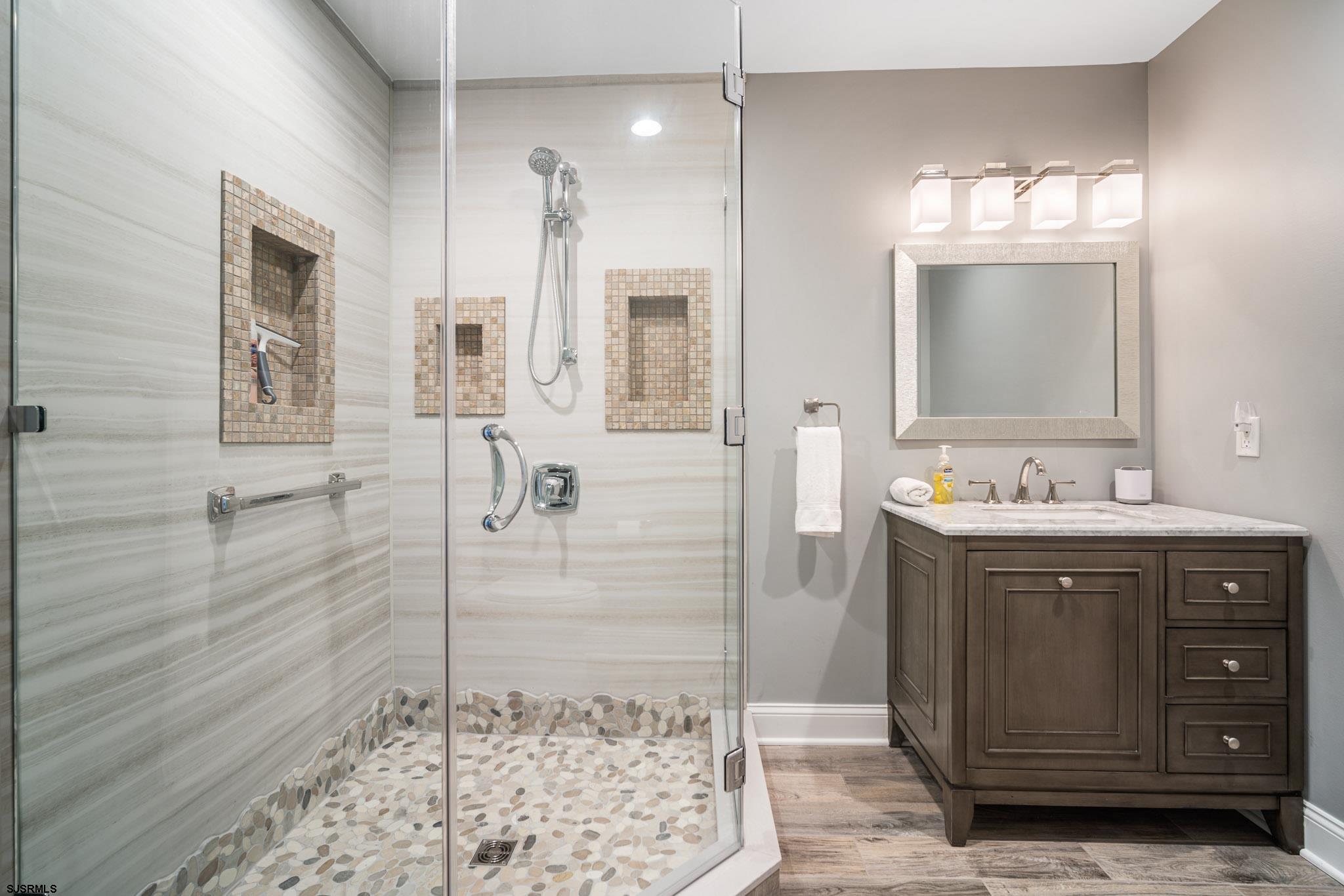 440 Hackney Place Brigantine, NJ 08203 - Photo 33 of 45 a bathroom with a sink shower and a mirror