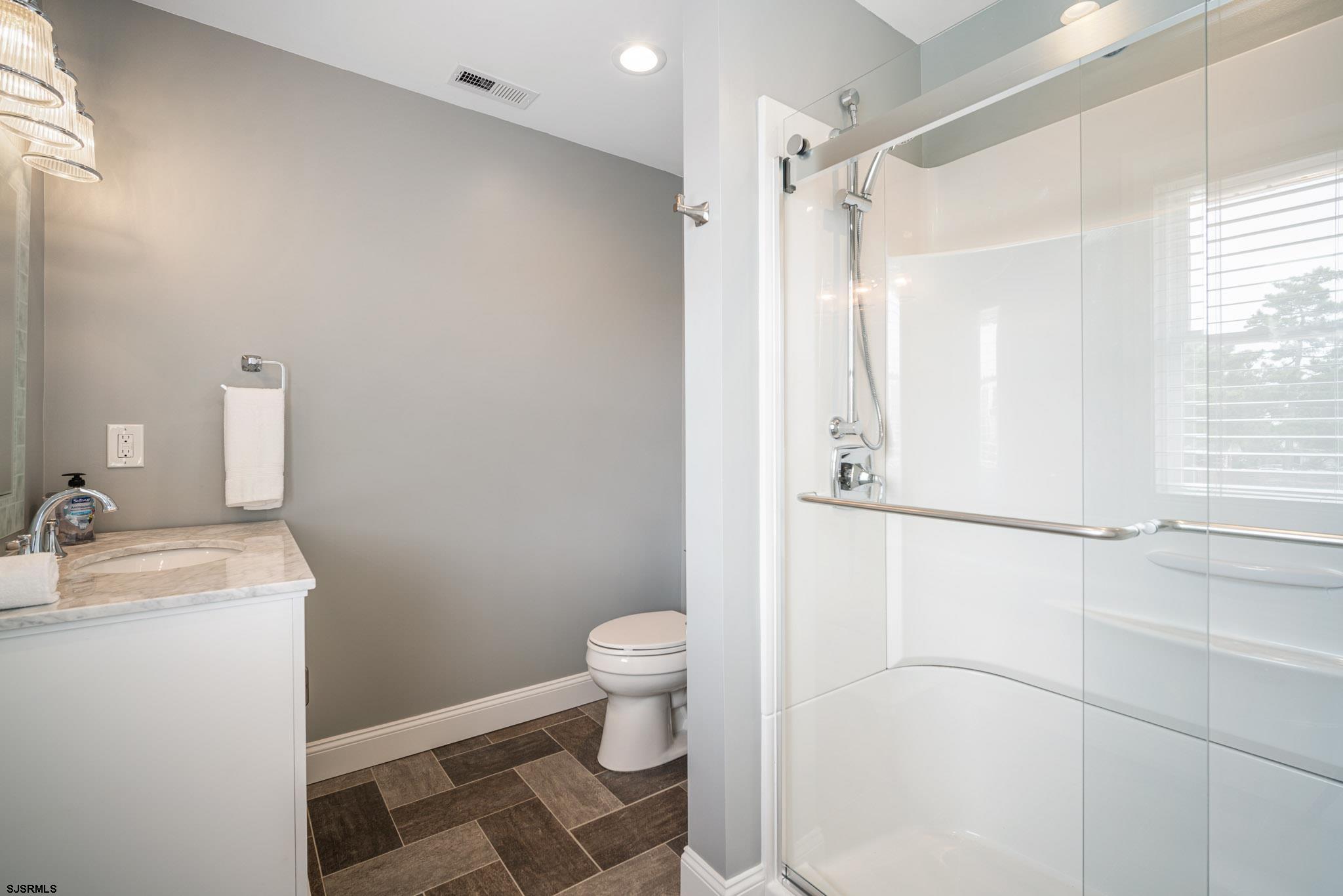 440 Hackney Place Brigantine, NJ 08203 - Photo 35 of 45 a bathroom with a sink toilet and shower