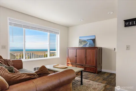 a living room with furniture a window and a flat screen tv