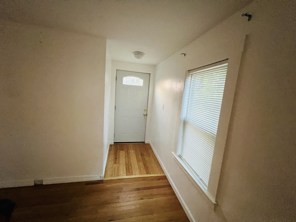 61 East Main Street Brockton, MA 02301 - Photo 11 of 20 a view of a room with wooden floor and window