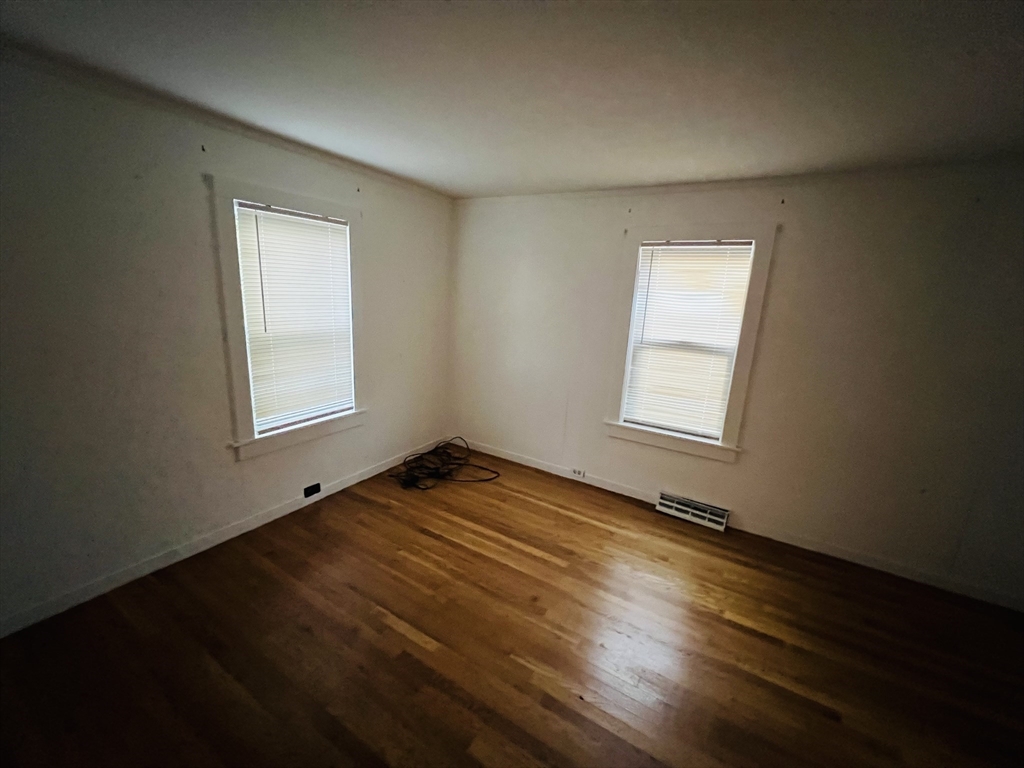 61 East Main Street Brockton, MA 02301 - Photo 13 of 20 a view of empty room with wooden floor and fan
