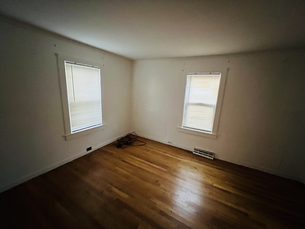 61 East Main Street Brockton, MA 02301 - Photo 14 of 20 a view of an empty room with wooden floor and a window