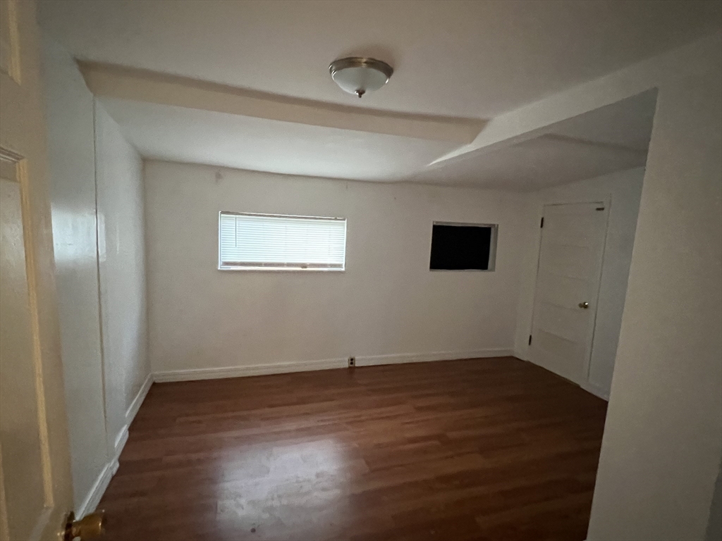 61 East Main Street Brockton, MA 02301 - Photo 19 of 20 a view of an empty room with wooden floor and a window