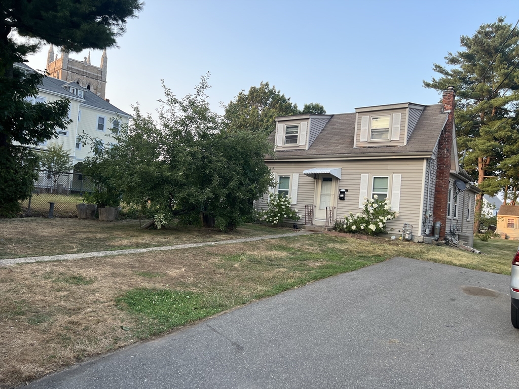 61 East Main Street Brockton, MA 02301 - Photo 4 of 20 a front view of a house with a yard and a garage