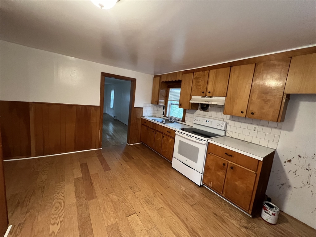 61 East Main Street Brockton, MA 02301 - Photo 8 of 20 a kitchen with granite countertop a refrigerator stove and sink