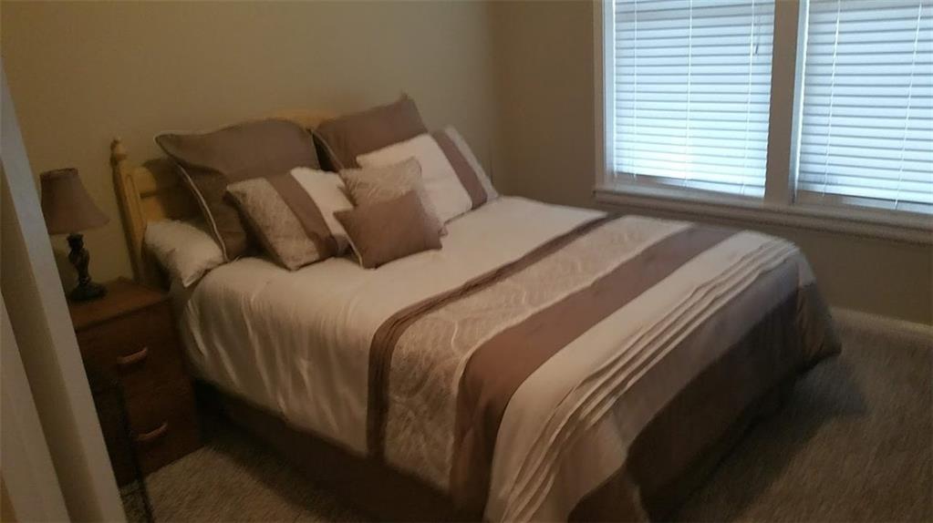 4363 Grove Field Park Northwest Suwanee, GA 30024 - Photo 12 of 18 a bed sitting in a bedroom next to a window