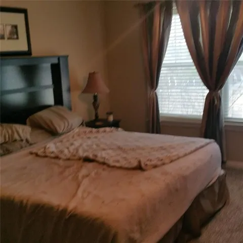 a bedroom with a bed and window