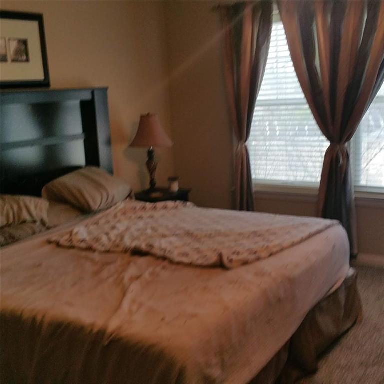 4363 Grove Field Park Northwest Suwanee, GA 30024 - Photo 2 of 18 a bedroom with a bed and window