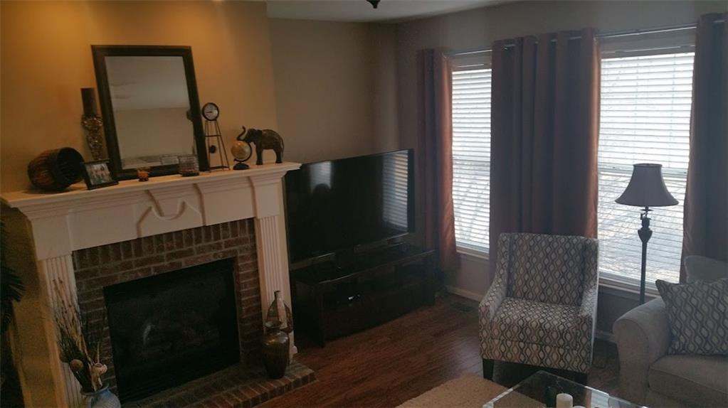 4363 Grove Field Park Northwest Suwanee, GA 30024 - Photo 7 of 18 a living room with furniture a flat screen tv and a fireplace