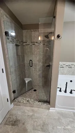 a bathroom with a shower and a sink