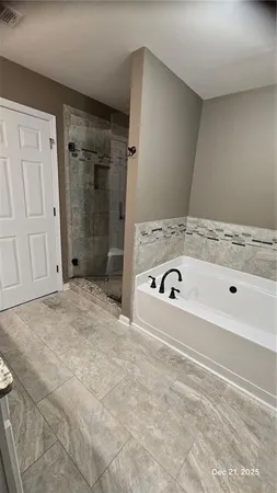 a bathroom with a bathtub and a shower