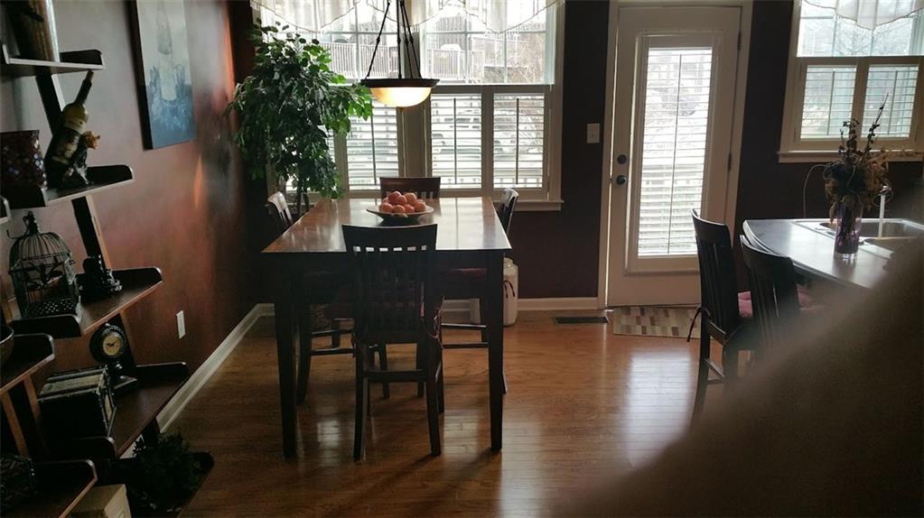 4363 Grove Field Park Northwest Suwanee, GA 30024 - Photo 9 of 18 a view of a dining room with furniture window and wooden floor