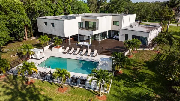 an aerial view of a house having swimming pool