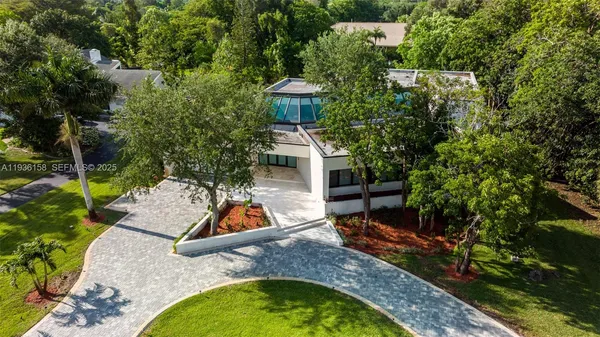 an aerial view of a house with a yard and lake view