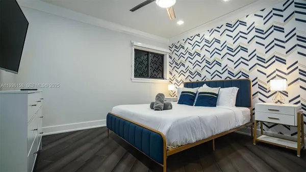 a bedroom with a bed and wooden floor