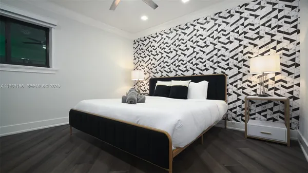 a bedroom with a bed and a large window