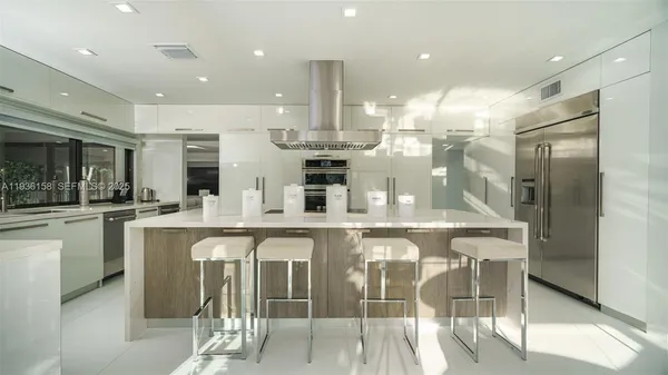 a large kitchen with granite countertop a counter top space and cabinets