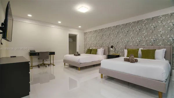 a living room with patio furniture and a floor to ceiling window
