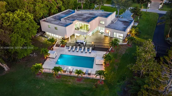 an aerial view of a house with garden space and street view