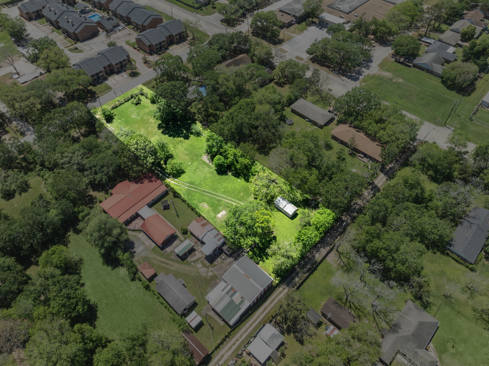 903 Brooks Avenue Rosenberg, TX 77471 - Photo 11 of 11 This angled view underscores the lot’s depth and central placement among established residences and newly built townhomes, reinforcing its development potential.