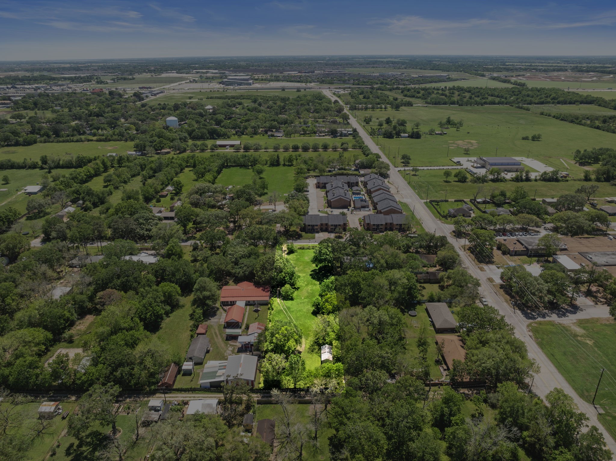 903 Brooks Avenue Rosenberg, TX 77471 - Photo 2 of 11 This aerial view captures the depth and scale of the lot, emphasizing its prime positioning and surrounding greenery—ideal for creating a private retreat or innovative build.
