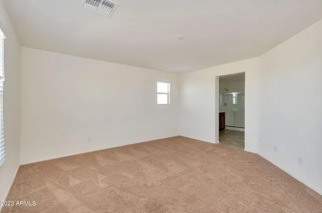 a spacious bathroom with a shower sink and mirror