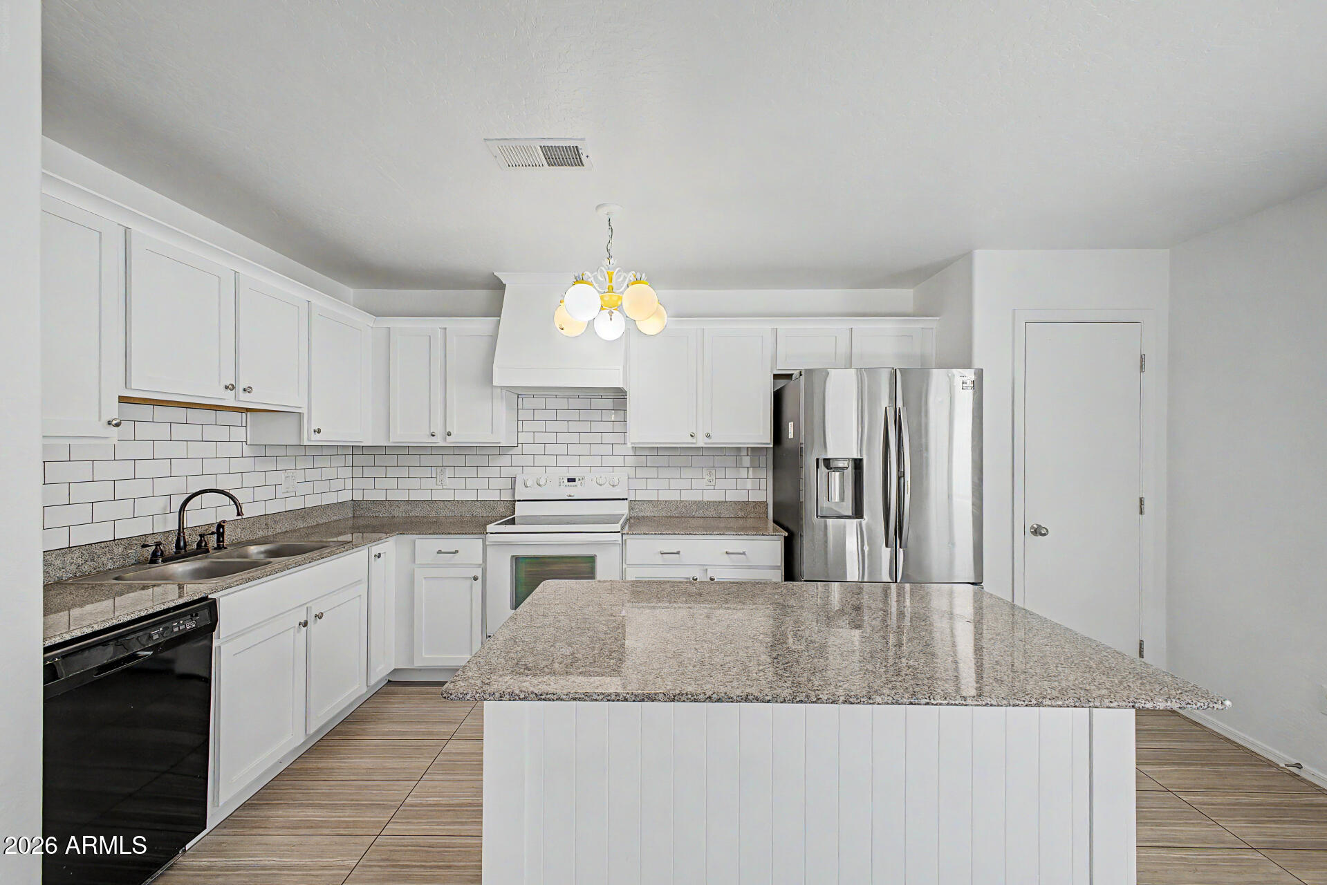 1882 West Rd Agent Street Apache Junction, AZ 85120 - Photo 7 of 26 a kitchen with stainless steel appliances granite countertop a sink refrigerator and cabinets