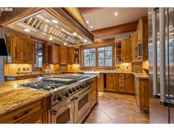 a kitchen with stainless steel appliances granite countertop a stove and a refrigerator