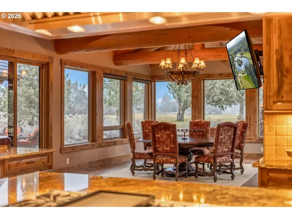 a view of a dining room with furniture large windows and wooden floor