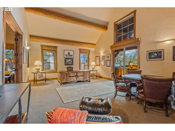 a living room with furniture and a dining table