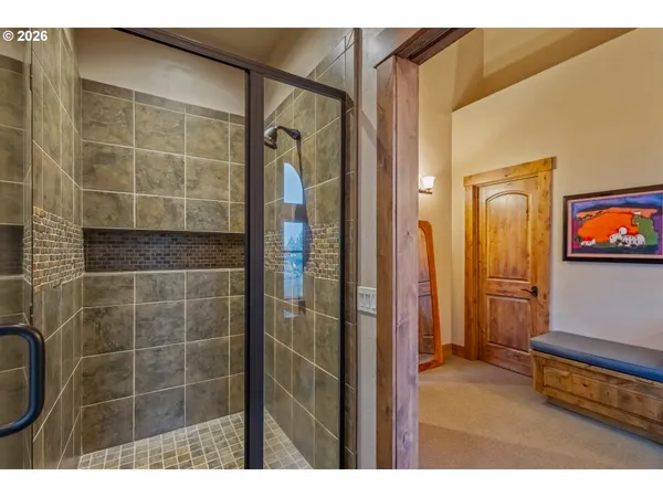 a bathroom with a shower and a mirror