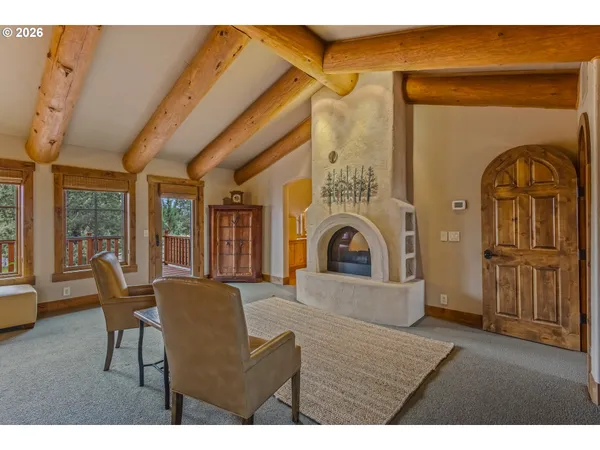 a living room with furniture a fireplace and wooden floor