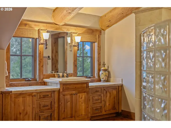 a bathroom with a sink a mirror and a window