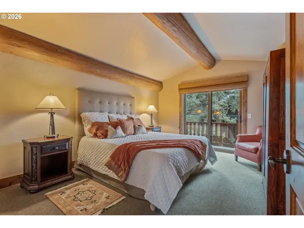 a bed room with a bed and a chair