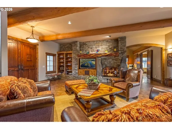 a bedroom with furniture and a large window