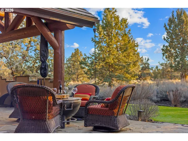 a backyard of a house with table and chairs