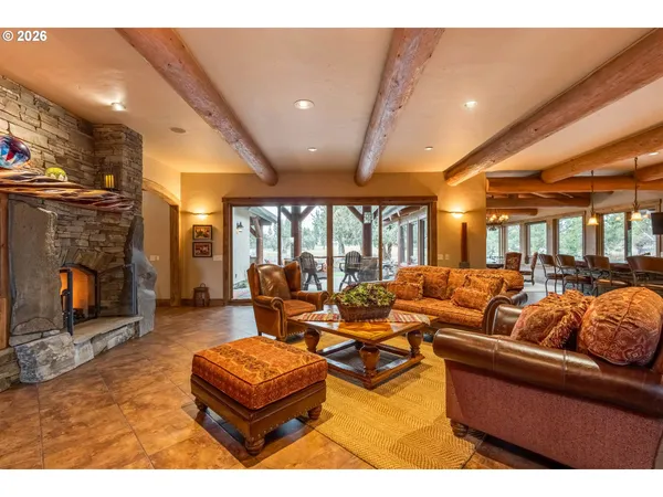 a living room with furniture a fireplace and a projector