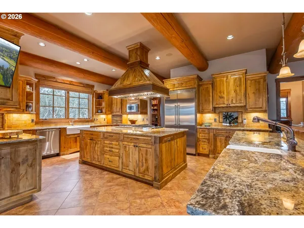a kitchen with stainless steel appliances granite countertop a sink and cabinets