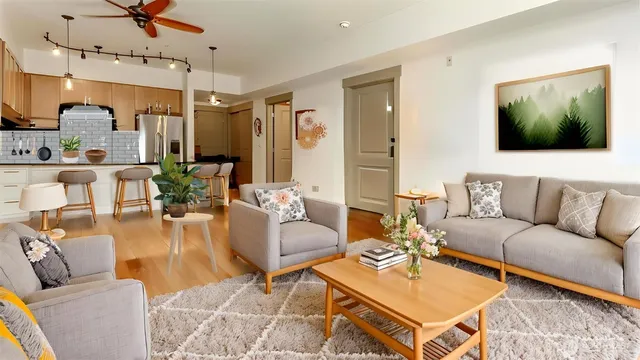 a living room with furniture and wooden floor