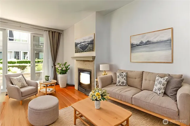 a living room with furniture a chandelier and a dining table
