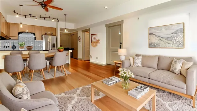 a living room with furniture a fireplace and a flat screen tv
