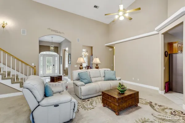 a living room with furniture and a chandelier
